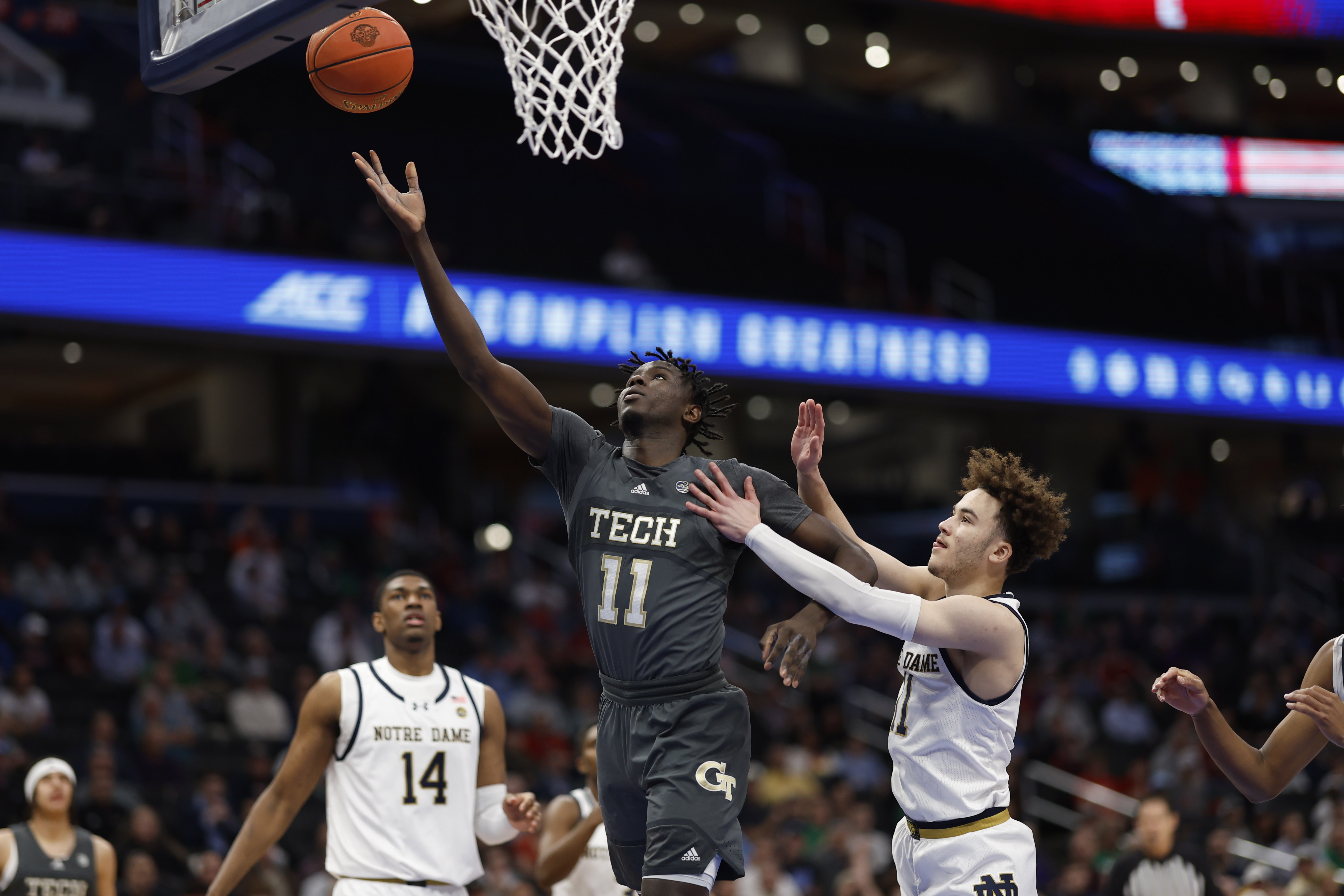 Mar 12, 2024; Washington, D.C., USA; Georgia Tech Yellow Jackets forward Baye Ndongo (11) shoots the ball as Notre Dame Fighting Irish guard Braeden Shrewsberry (11) defends in the first half at Capital One Arena. Mandatory Credit: Geoff Burke-USA TODAY Sports